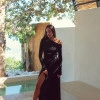 A suit with top an asymmetric neck and a scented skirt black