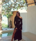 A suit with top an asymmetric neck and a scented skirt black