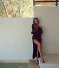 A suit with top an asymmetric neck and a scented skirt black