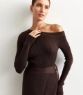 A suit with top an asymmetric neck and a scented skirt chocolate